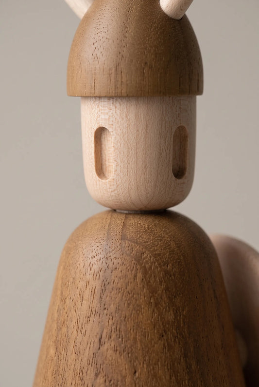 Extreme macro view of Nordic Mythos Viking Wood Sculpture crafted from Solid Teak and Natural Maple Wood, highlighting light-absorbing matte wood grain micro-texture under raking side light.