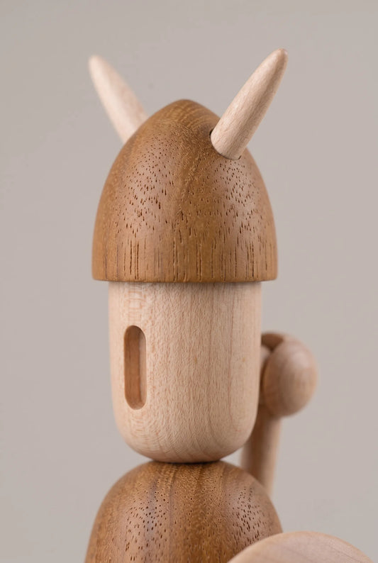 Extreme macro view of Nordic Mythos Viking Wood Sculpture crafted from Solid Teak and Natural Maple, highlighting unprocessed teak and maple grain micro-texture under raking side light.