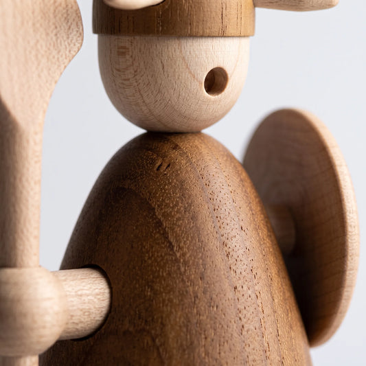 Extreme macro view of Nordic Mythos Viking Wood Sculpture crafted from Solid Teak and Natural Maple Wood, highlighting glare-free matte micro-texture under raking side light.