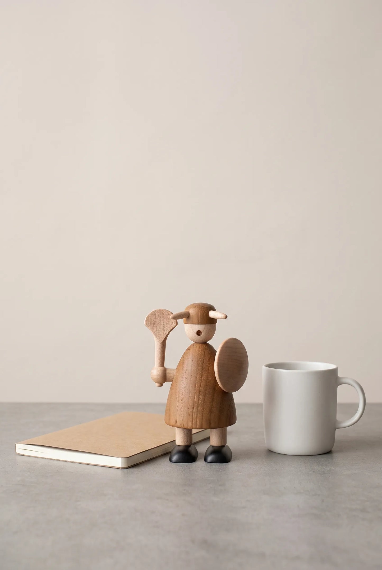 Nordic Mythos Viking Wood Sculpture measuring 12 cm, crafted from Solid Teak and Natural Maple Wood, juxtaposed with unbranded everyday desk objects for scale.