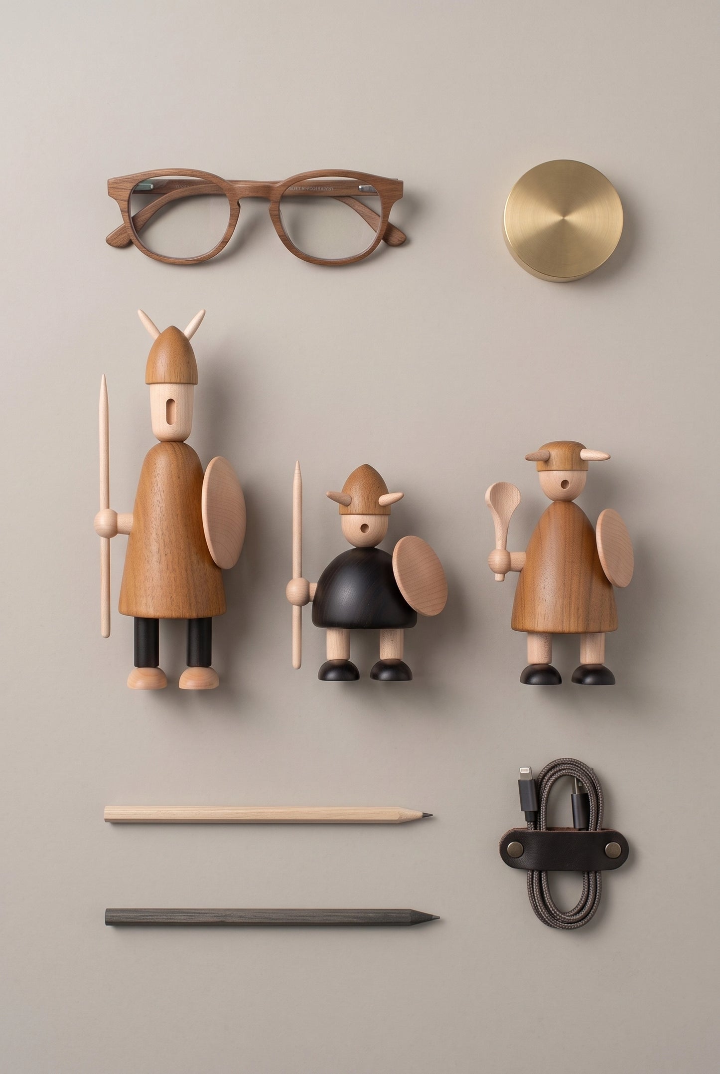 90-degree top-down knolling view of Nordic Mythos Viking Wood Sculptures crafted from Solid Teak and Natural Maple with Glare-free matte natural oil surface, arranged with essential desk items.