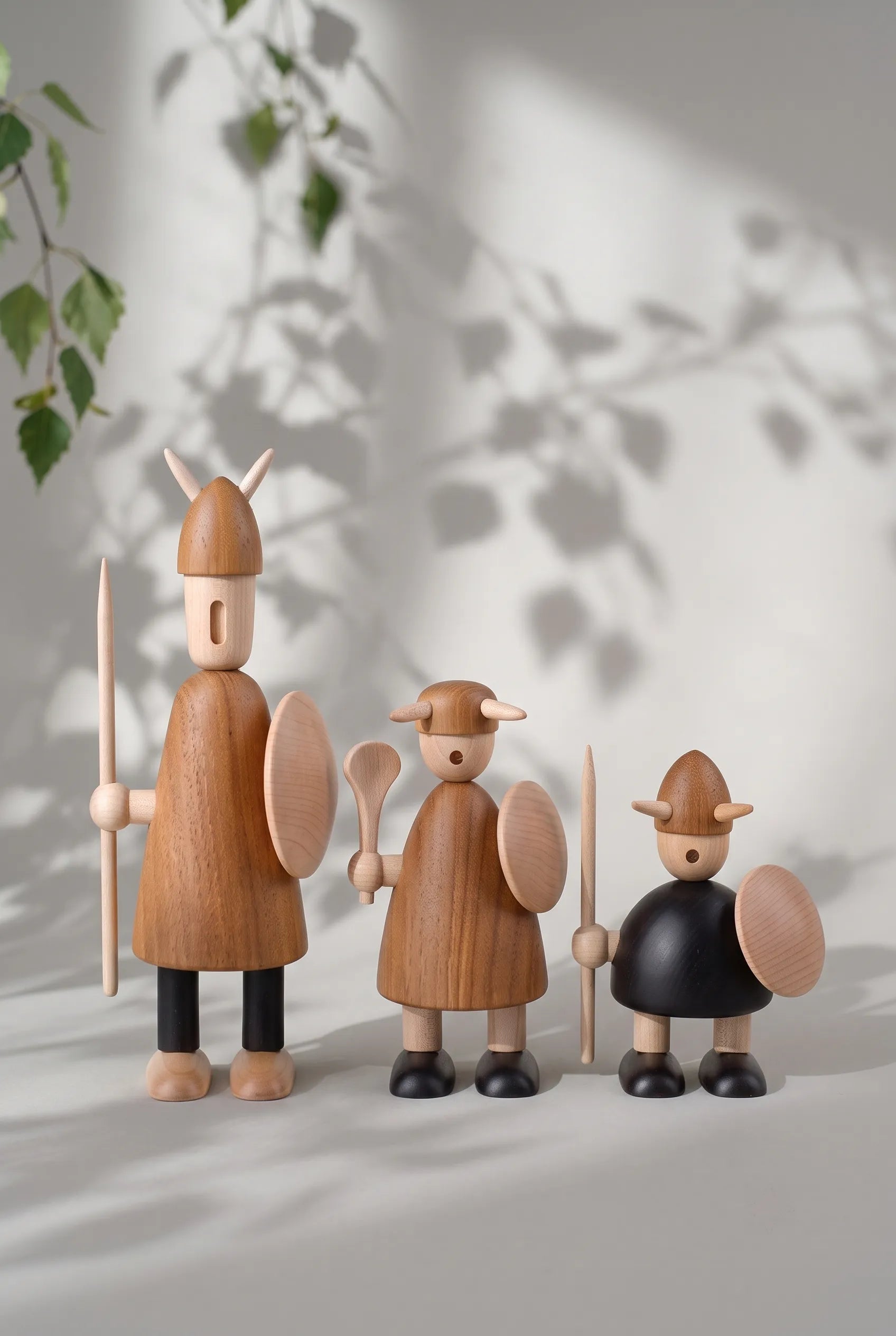 Nordic Mythos Viking Wood Sculptures crafted from Solid Teak and Natural Maple with Glare-free matte natural oil finish, resting under soft Nordic birch shadows and natural sunlight.
