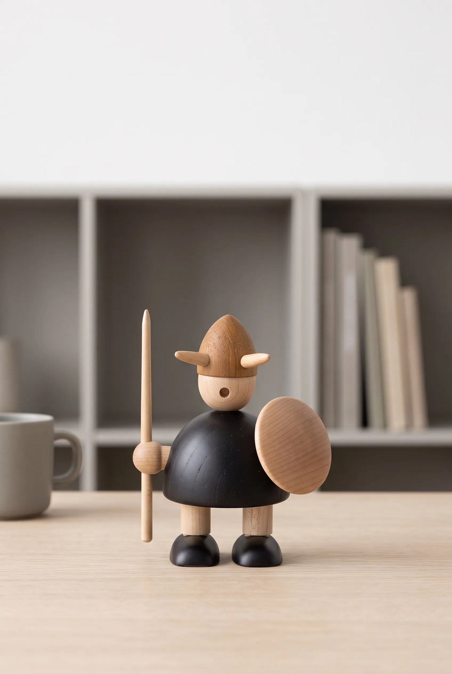 Nordic Mythos Viking Wood Sculpture crafted from solid teak and natural maple wood with glare-free matte natural wood finish, positioned in a minimalist workspace with muted environmental tones.