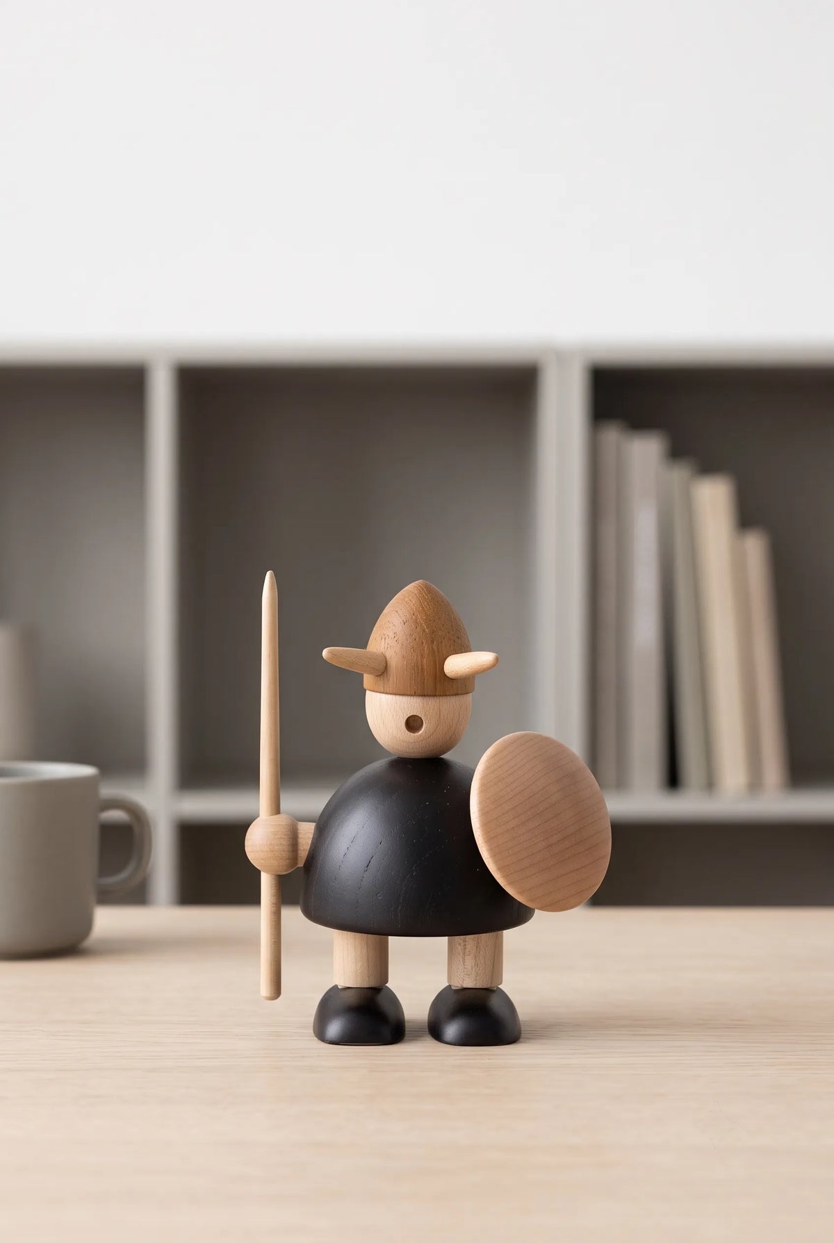 Nordic Mythos Viking Wood Sculpture crafted from solid teak and natural maple wood with glare-free matte natural wood finish, positioned in a minimalist workspace with muted environmental tones.