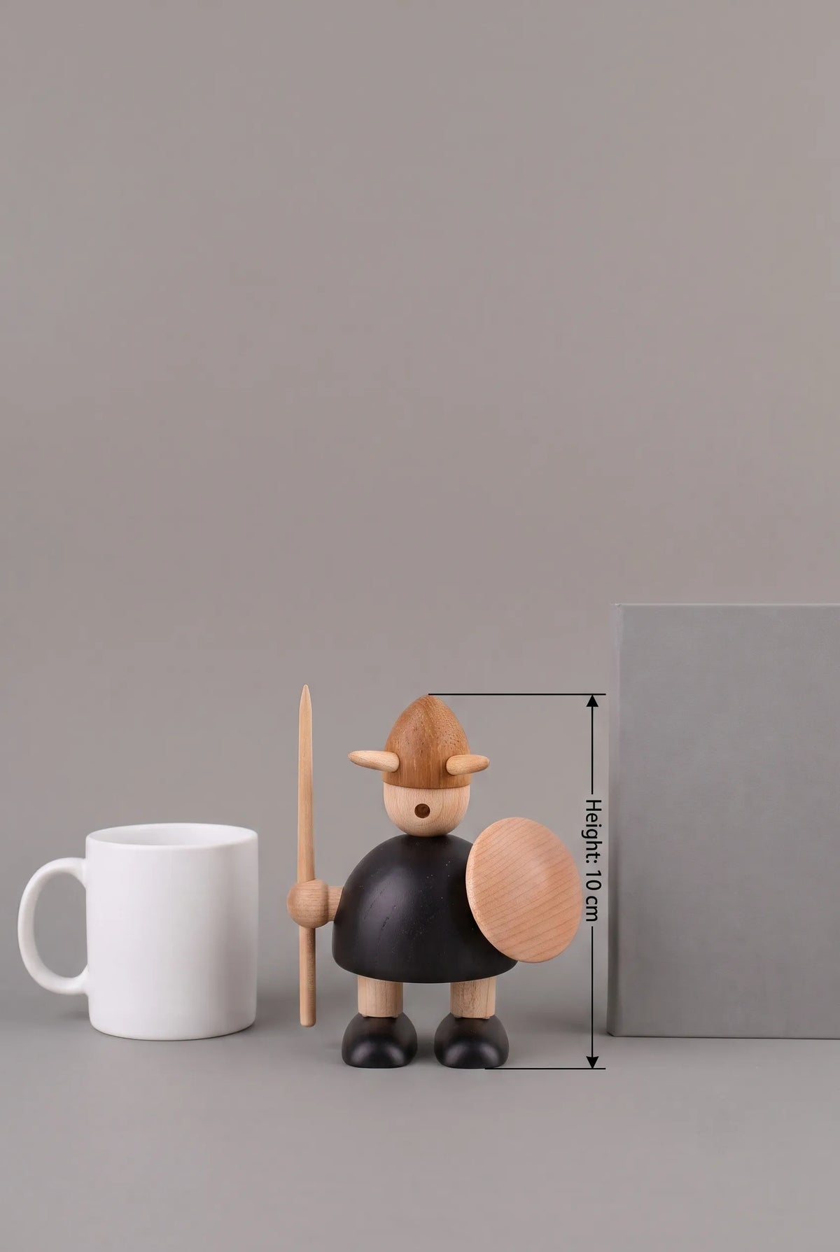 Nordic Mythos Viking Wood Sculpture measuring Height: 10 cm, crafted from solid teak and natural maple wood, juxtaposed with unbranded everyday desk objects for scale.
